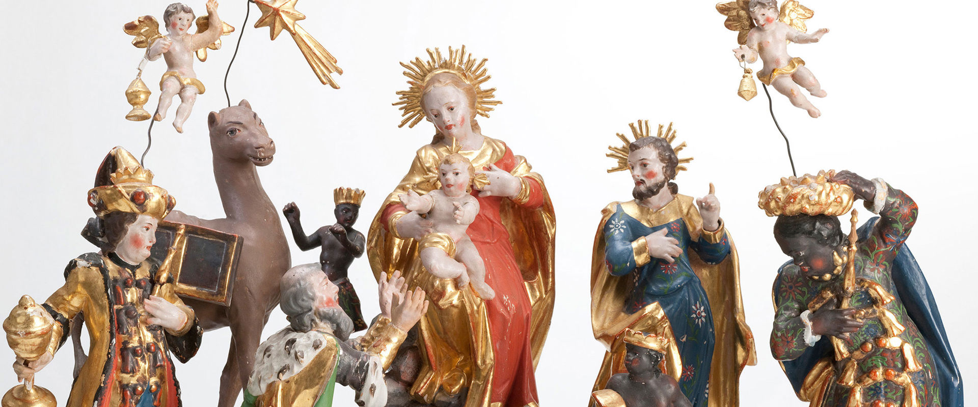 Nativity figures Carved figures of a nativity scene. In the centre Mary and Joseph with the Christ child.